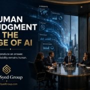 Business leaders reviewing AI-generated insights while retaining human judgment and accountability at The Syed Group, led by Syed Raheel Shahzad