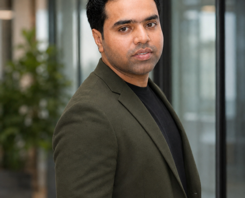 Syed Raheel Shahzad — Standing Executive Portrait Syed Raheel Shahzad (سيد راحيل شهزاد) standing in a professional jacket